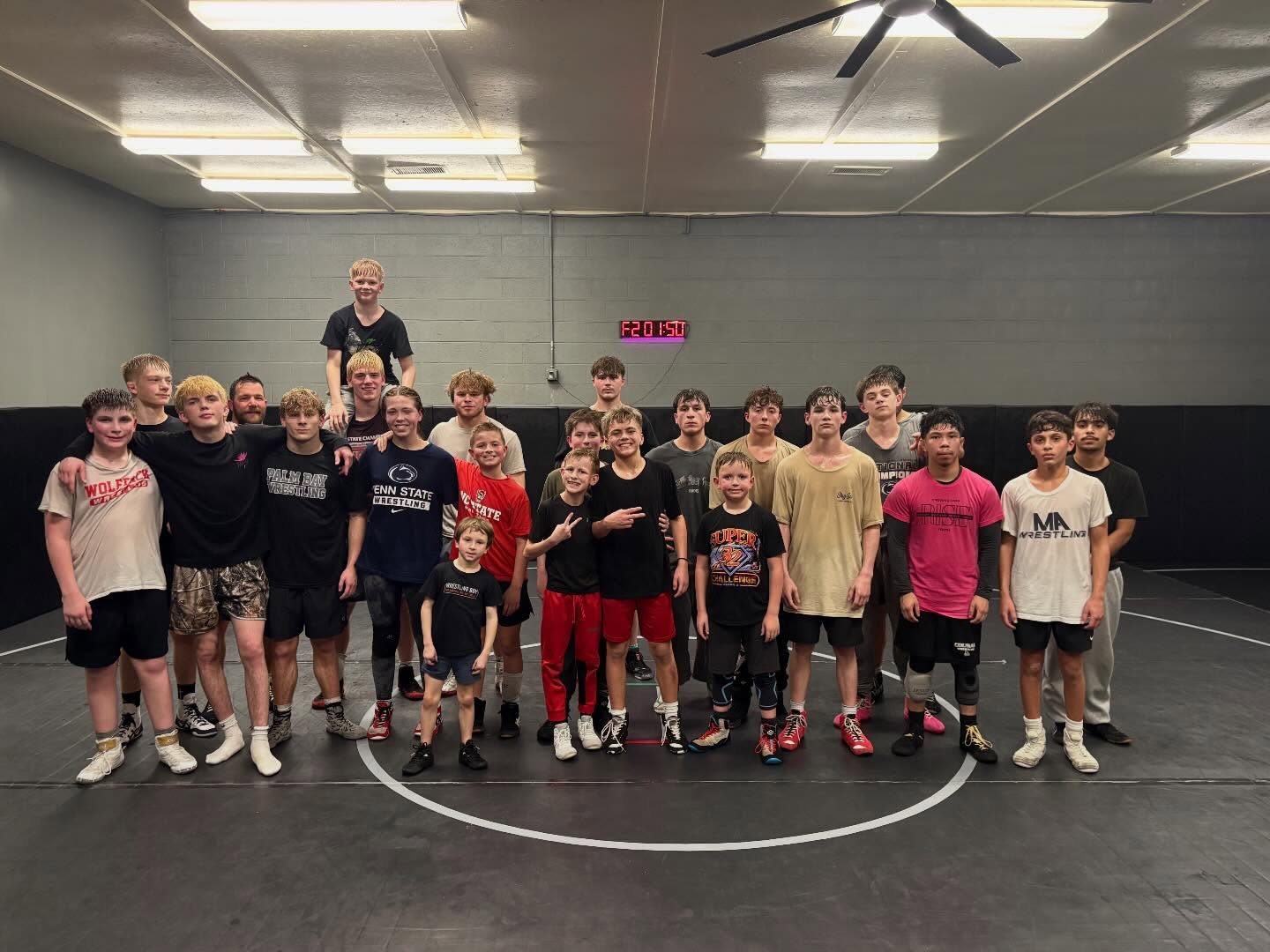 Around twenty-five Raw West athletes of all ages gathered on the mat after practice.